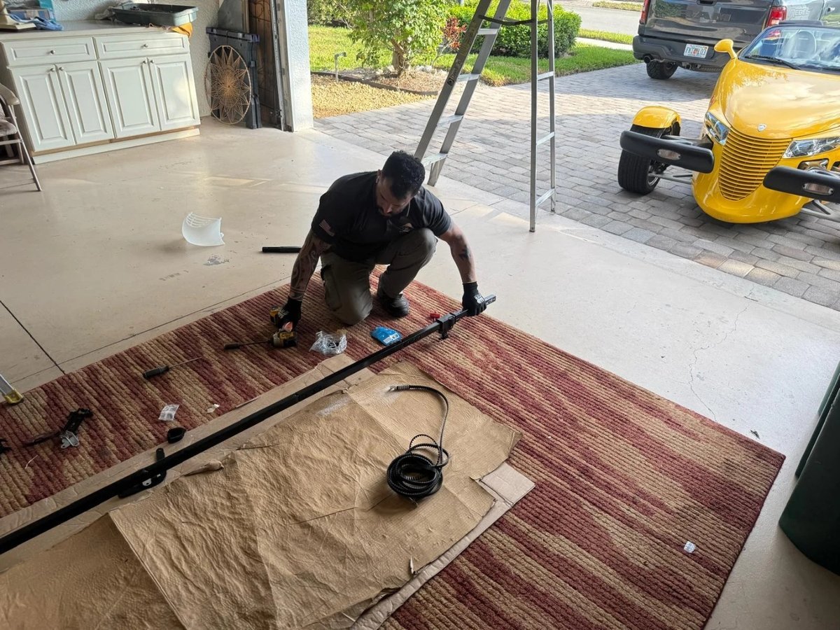 Worker arranging door hardware on a protective floor mat